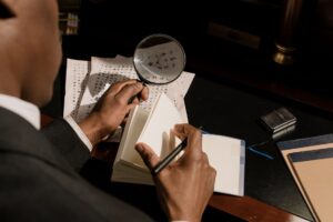 虫眼鏡で資料を調査するイメージ